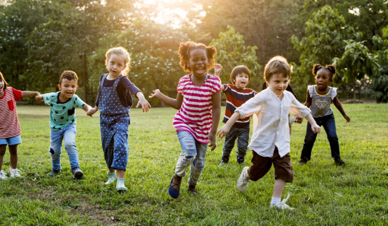 Group of Diverse Kids Playing at the Field Together