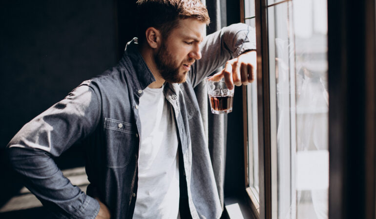 Man drinker depressed with bottle of whiskey